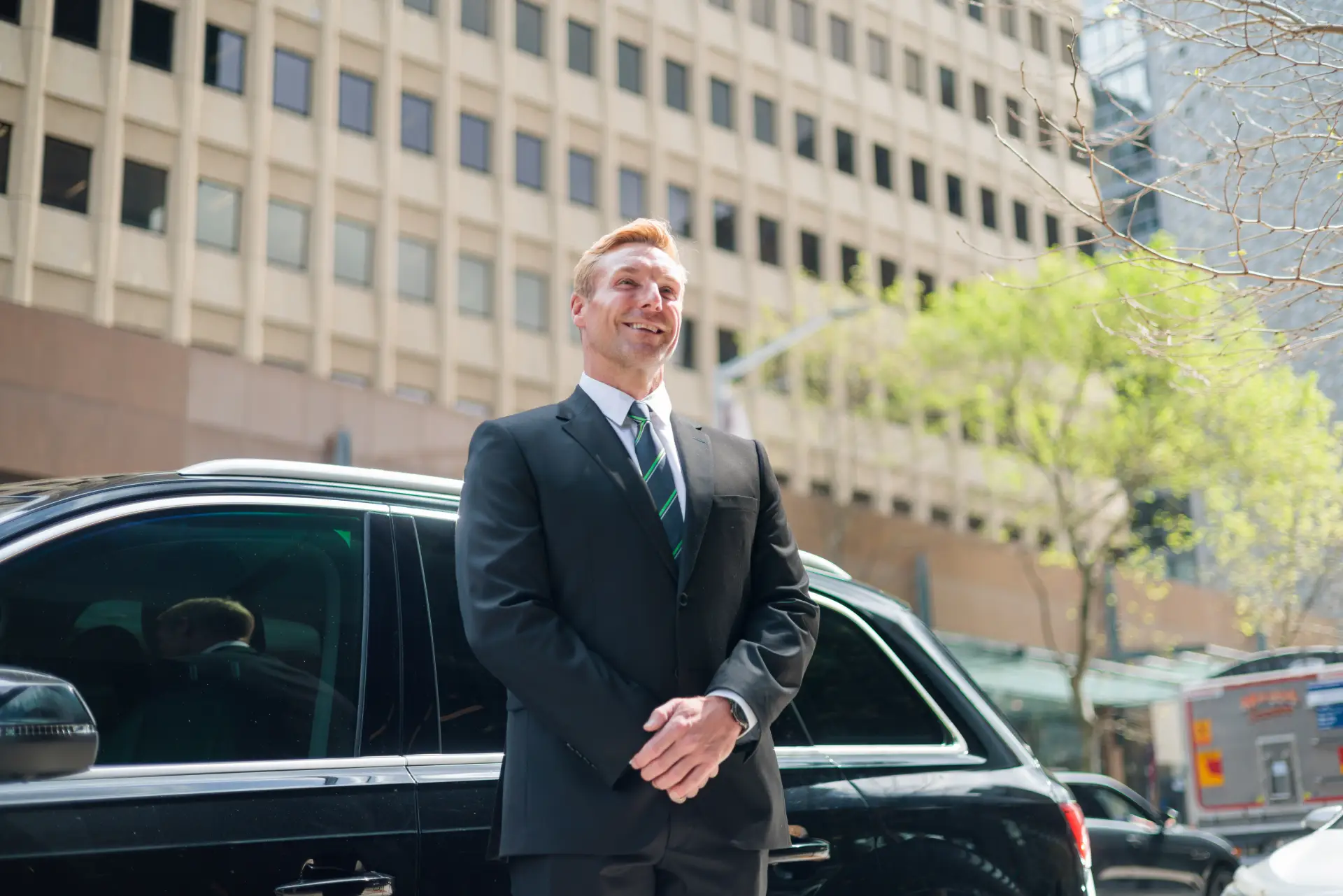 CarAustralia20240910-00056 ben-williams.com Professional Chauffeur from standing by vehicle with a welcoming smile - Car Australia